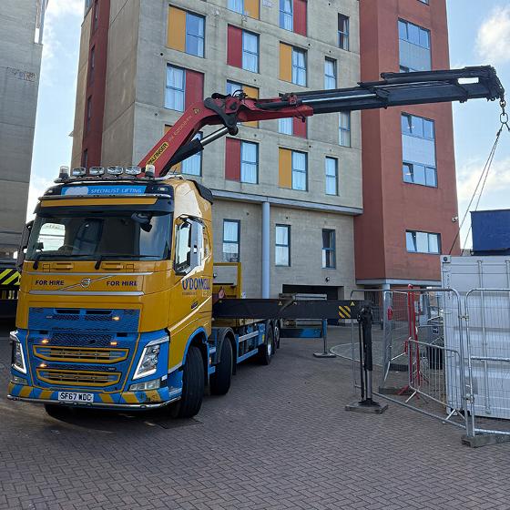 excavator bucket digging through construction debris including dirt concrete and metal rebar at a building site associated with five construction elements
