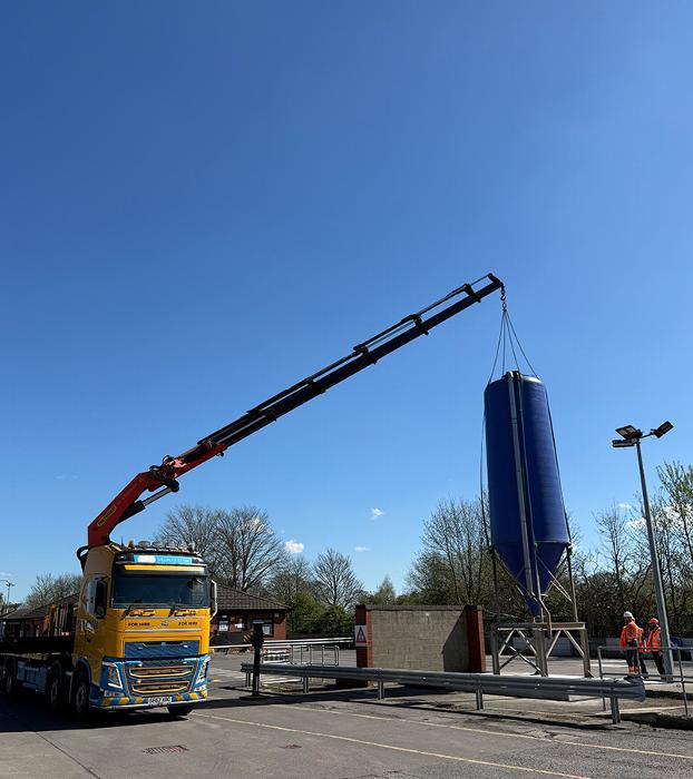 crane lifting equipment at construction site with specialized truck for hire
